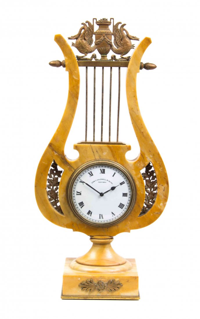 An Empire Style Sienna Marble Mantel Clock Height 14: An Empire Style Sienna Marble Mantel Clock of lyre form, the circular dial with Roman numerals. Height 14 3/4 inches. Property from the Estate of James J. McKiernan, Kansas City, Missouri