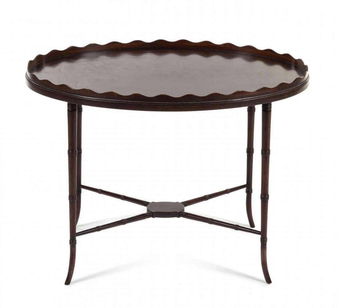 A Regency Style Mahogany Tray Table Height 21 1/4 x: A Regency Style Mahogany Tray Table JOHANN TAPP, 20TH CENTURY having an oval galleried top raised on ring turned supports and joined by conforming X-form stretchers. Height 21 1/4 x width 29 x depth 2