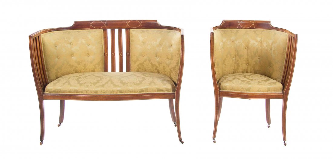 An Edwardian Mother-of-Pearl Inlaid Salon Suite LATE: An Edwardian Mother-of-Pearl Inlaid Salon Suite LATE 19TH/EARLY 20TH CENTURY comprising a settee and an armchair, each with padded back and seat, raised on splayed legs ending in casters. Width of set