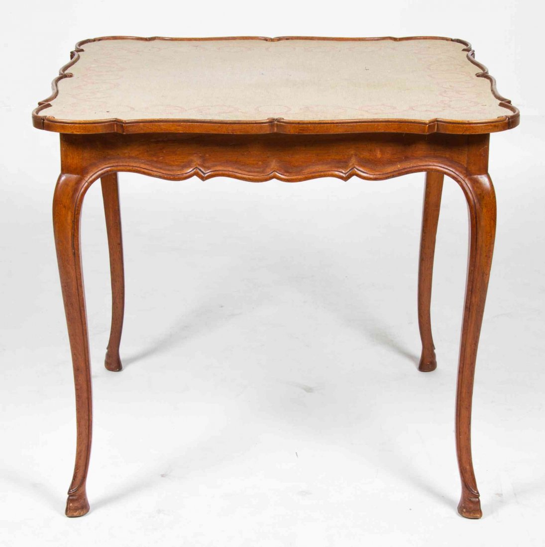 A French Provincial Oak Games Table Height 29 x width: A French Provincial Oak Games Table 20TH CENTURY having a needlepoint inset shaped square top over the conforming frieze set with opposing drawers, raised on carved cabriole legs. Height 29 x width 32