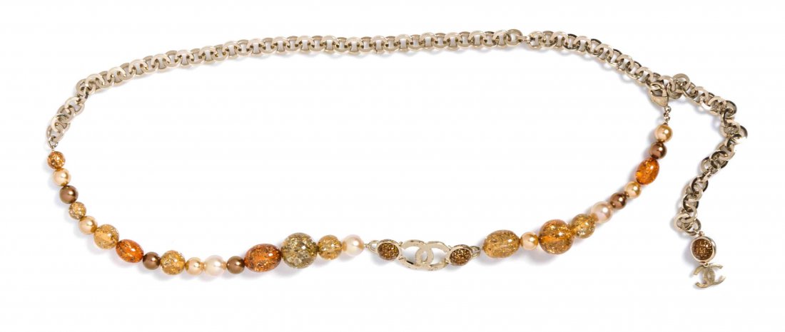 A Chanel Silvertone Chain Link Belt,: A Chanel Silvertone Chain Link Belt, with alternating faux pearl and gold speckle resin beads and an interlocking 'C' logo enhancer. Stamped: Chanel. Property from the Estate of Rita Dee Hassenfeld, P