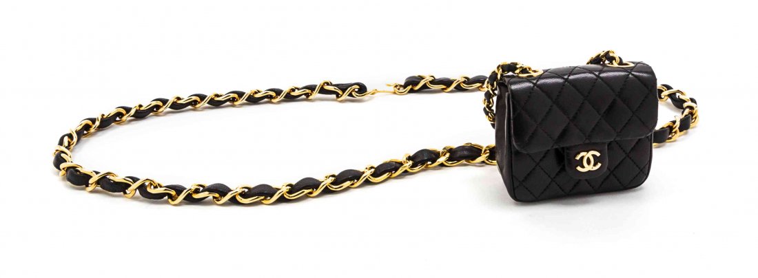 A Chanel Black Leather Quilted Flap Bag on a Belt, 3: A Chanel Black Leather Quilted Flap Bag on a Belt, goldtone hardware, with an interlocking 'C' logo, adjustable interwoven leather and chain link strap. Stamped: Chanel. 3 1/2 x 3 x 1 1/2 inches. Prop
