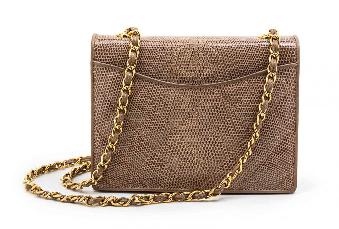 A Chanel Taupe Quilted Lizardskin Flap Bag, 7 1/2 x 6 x: A Chanel Taupe Quilted Lizardskin Flap Bag, circa 1990, goldtone hardware, foldover flap with slip pocket and button closure, quilted interlocking 'C' logo, interwoven leather and chain link strap, in