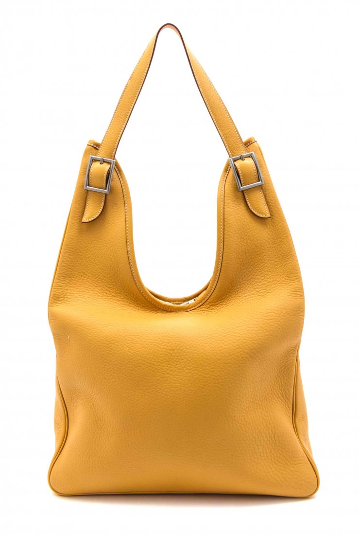 An Hermes Gold Leather Massai Bag, 17 1/2 x 10 x 2 1/2: An Hermes Gold Leather Massai Bag, 2000, palladium hardware, fabric lining with interior zippered pocket, blindstamp square D. Stamped: Hermes. 17 1/2 x 10 x 2 1/2 inches. Property from the Estate of 