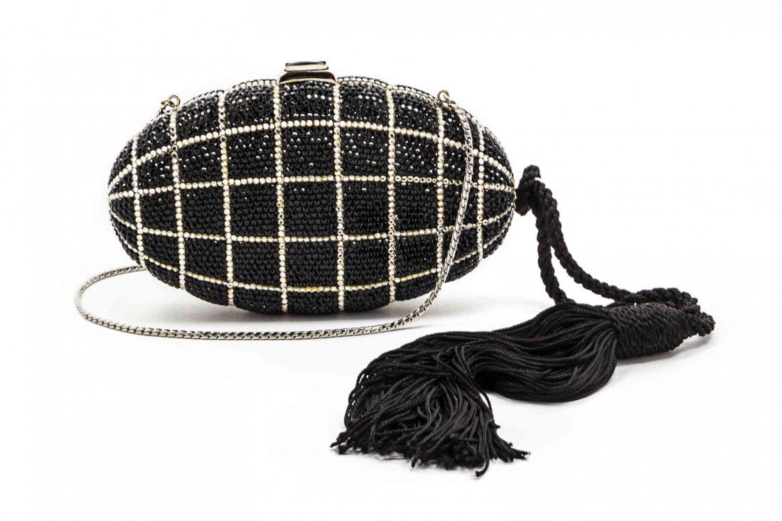 A Judith Leiber Black and White Swarovski Crystal: A Judith Leiber Black and White Swarovski Crystal Minaudiere, with a faux onyx push-button clasp, a detachable black silk fringe tassel and a silvertone drop-in chain. Includes a goldtone comb. Stampe
