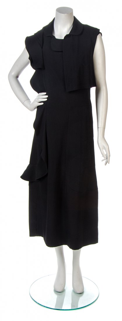 A Comme des Garcons Black Wool Dress, Size M.: A Comme des Garcons Black Wool Dress, Fall/Winter 1995, sleeveless dress with a vertical self ruffle applique to the right side of the dress, with an attached single shoulder vest. Labeled: Comme des