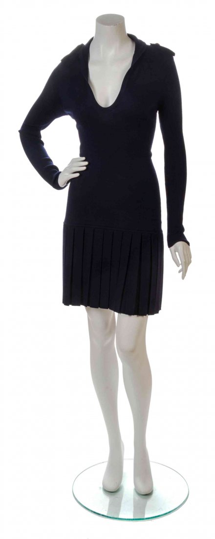 An Alexander McQueen Navy Wool Knit Dress, Size M.: An Alexander McQueen Navy Wool Knit Dress, V-neckline, modified stand collar, epaulets to the shoulders, drop waist with an accordion pleated skirt. Labeled: Alexander McQueen. Size M. Property from t