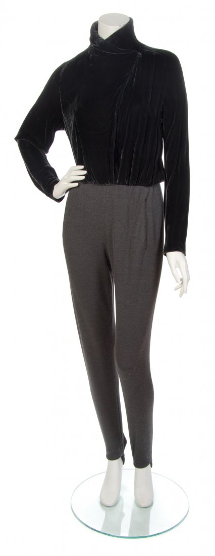 A Donna Karan Graphite Velvet Jumpsuit,: A Donna Karan Graphite Velvet Jumpsuit, 1990s, velvet bodice with two snap button closures and a single self covered button closure at the neckline, with attached grey stirrup pants. Labeled: Donna Ka