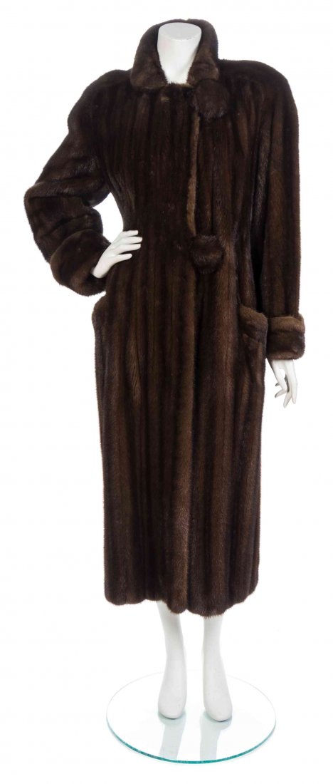 An I. Magnin Brown Mink Coat,: An I. Magnin Brown Mink Coat, with three hook and eye center front closures and two patch pockets. Labeled: I.Magnin. Condition: Measurements: Bust: 19 1/2" flat Waist: 21" flat Hip: 23" flat Length: