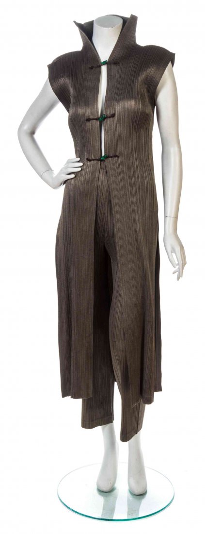 An Issey Miyake Taupe Pleated Pant Ensemble, Tunic size: An Issey Miyake Taupe Pleated Pant Ensemble, comprised of a long sleeveless tunic with three green bead toggle center front closures, together with a pair of pleated trousers. Each labeled: Issey Miya
