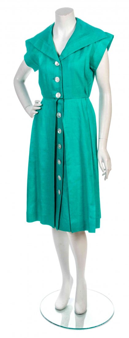 An Yves Saint Laurent Green Linen Dress, Size 36.: An Yves Saint Laurent Green Linen Dress, 1970s, sailor collar with large mother of pearl buttons down the center front, two side seam pockets and inverted pleats to the skirt. Labeled: Saint Laurent R