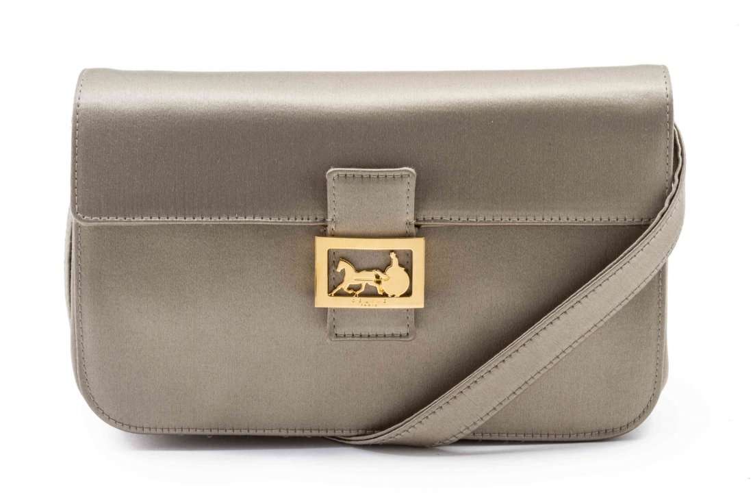A Celine Taupe Satin Clutch, 7 1/2 x 4 x 2 inches.: A Celine Taupe Satin Clutch, foldover flap with goldtone hardware, detachable shoulder strap, interior zippered pocket with black canvas lining. Stamped: Celine. 7 1/2 x 4 x 2 inches. Property from th