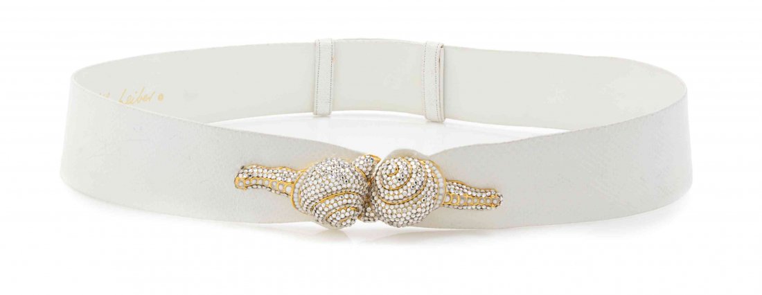 A Judith Leiber White Karung Snakeskin Belt, Adjustable: A Judith Leiber White Karung Snakeskin Belt, with a Swarovski rhinestone and pearl snail buckle closure. Stamped: Judith Leiber. Adjustable strap. Property from the Estate of Rita Dee Hassenfeld, Palm