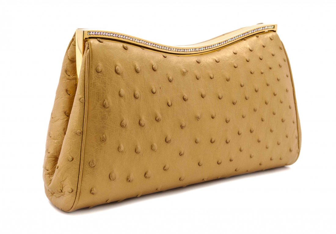 A Judith Leiber Metallic Gold Ostrich Evening Bag, 9: A Judith Leiber Metallic Gold Ostrich Evening Bag, goldtone Swarovski frame, with slip and zippered pockets, and ivory satin lining. Stamped: Judith Leiber. 9 1/2 x 5 x 1 1/2 inches. Property from the