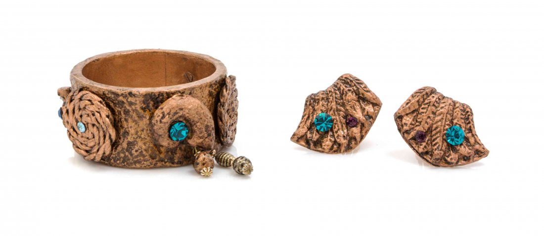A Gerda Lynggaard for Monies Coppertone and Rhinestone: A Gerda Lynggaard for Monies Coppertone and Rhinestone Demi Parure, comprised of a textured bangle bracelet, together wth a pair of earclips. Unsigned. Condition: Overall excellent condition. Please n