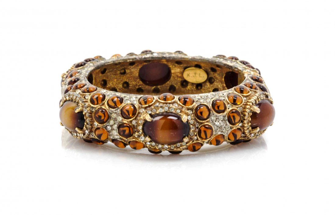 A Kenneth Jay Lane Faux Amber Cabochon Hinged Bracelet,: A Kenneth Jay Lane Faux Amber Cabochon Hinged Bracelet, with pave rhinestones and tiger-eye cabochons. Stamped: K.J.L Property from a Private Collection