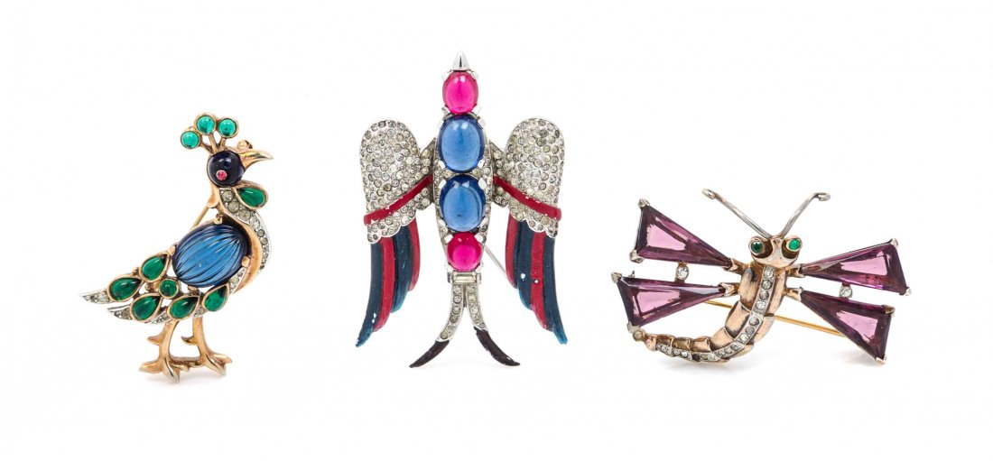 A Group of Three Trifari Brooches,: A Group of Three Trifari Brooches, comprised of a goldtone amethyst dragonfly brooch, a silvertone faux ruby, faux sapphire and pave rhinestone bird brooch, and a goldtone faux emerald and faux sapphi