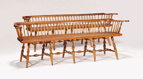 Pair of low back Windsor settees, pennsylvania,: Pair of low back Windsor settees pennsylvania, late 18th century The molded rail on flattened arms, incised plank seat raised on ten baluster turned tapering legs joined by bulbous turned stretchers.