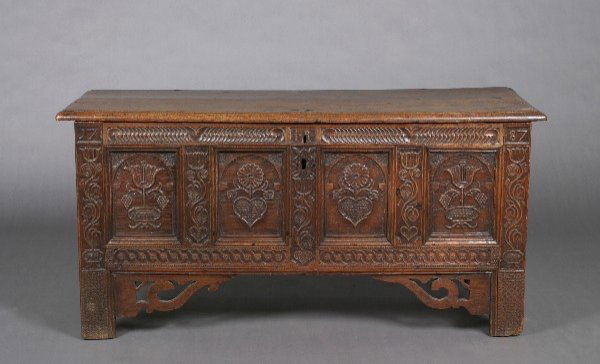 A Provincial German Oak Blanket Chest, Height 27 x: A Provincial German Oak Blanket Chest, 18th century with later elements, the rectangular hinged lid over a paneled chest carved with flowers and scrolling decoration throughout. Height 27 x width 55 3