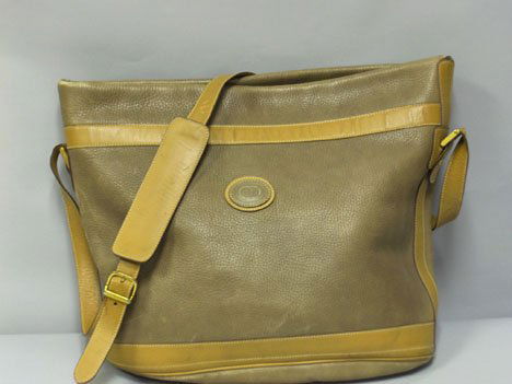 Two Gucci purses, , One large bucket" purse in b: Two Gucci purses One large bucket" purse in beige leather, adjustable shoulder strap, gold hardware; with a small round white Gucci-logo canvas purse."