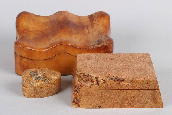 A Contemporary Burl Hinged Dresser Box, Height of f: A Contemporary Burl Hinged Dresser Box, by Michael Elkan, together with a smaller box and a leather covered shaped box. Height of first 2 1/2 x width 8 x depth 5 1/4 inches. Property from the Estate o
