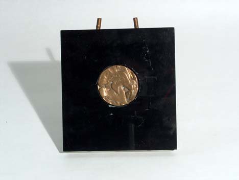 CIRCULAR BRONZE SCULPTURE 20th c. Modern design m: CIRCULAR BRONZE SCULPTURE 20th c. Modern design medallion in a Lucite frame. Signed Marcel Duchamp #16/100.