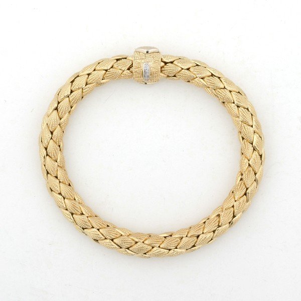 A Lady's 18 Karat Yellow Gold Flexible Bangle Brac: A Lady's 18 Karat Yellow Gold Flexible Bangle Bracelet, Chimento, containing one small round brilliant cut diamond on the clasp, stamp: * 408.V1 750 MOD. DEP SUN hallmark, CHIMENTO. 21.90 dwts. 8 inch