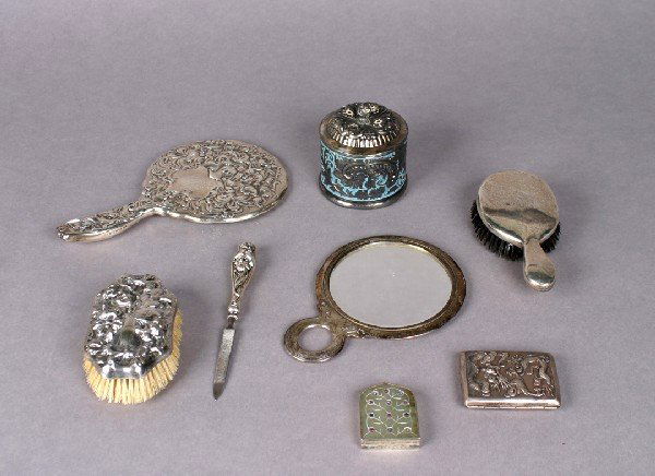An Assembled Dresser Set,: An Assembled Dresser Set, comprising a Whiting silver Art Noveau hand held mirror, a silver nail file, a silver plate and enamel dresser box, a Gorham silver and tortoise comb, a silver handled brush,