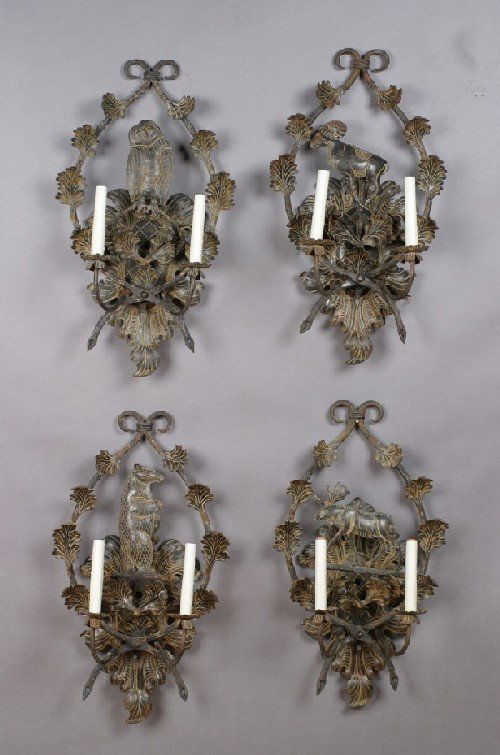 A Group of Four Two-Light Iron Wall Sconces, Heig: A Group of Four Two-Light Iron Wall Sconces, each having a backplate depicting an animal surrounded by a leafy border, comprising an owl, a bear, a moose, and a ram. Height of backplate 28 inches.
