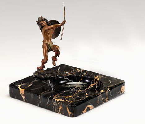 Franz Bergmann cold painted bronze of a Native Am: Franz Bergmann cold painted bronze of a Native American early 20th century Realistically modeled as a standing warrior holding a spear and a shield, Bergmann seal, mounted on a onyx ashtray. H: 6 1/2