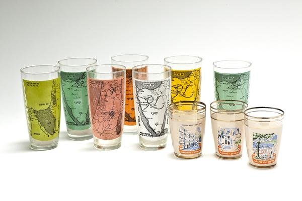 Eretz Israel Drinking Glasses – After the Six Day War: 1-7. Seven drinking glasses made after the Six Day War, [1967]. Printed on the glasses in two colors are maps that portray the achievements of the Israeli army during the war (each glass portrays a di