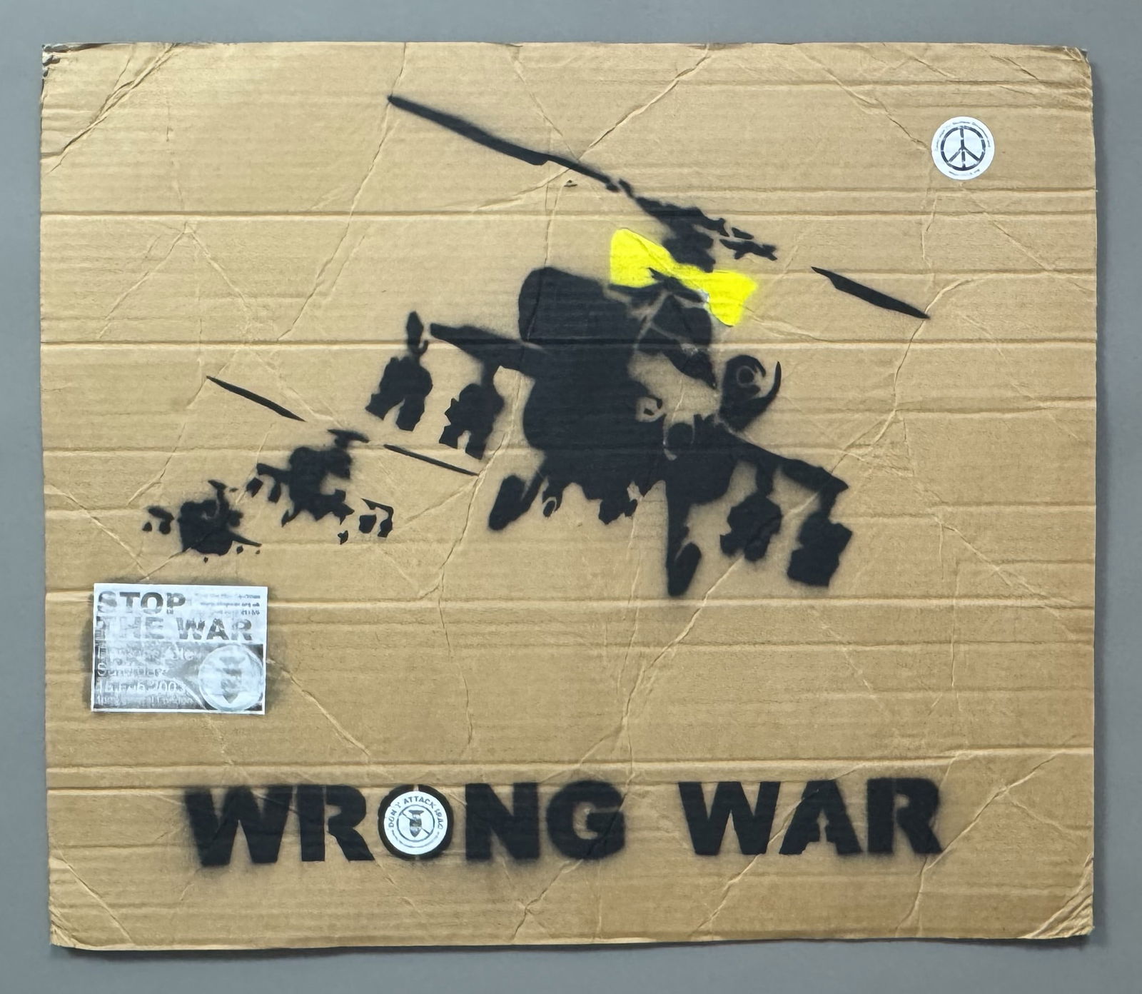 BANKSY (Né en 1974), d’après. Happy choppers , Wrong War , 2003.: BANKSY (Né en 1974), d’après. Happy choppers , Wrong War , 2003. Pochoir à l’aérosol sur carton de récupération. Stickers de la manifestation “Campaign