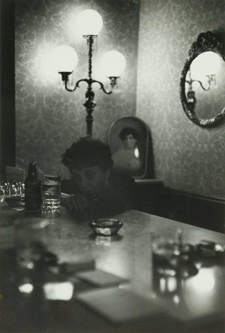 SAUL LEITER (1923-2013) Woman leaning on a bar with a: SAUL LEITER (1923-2013) Woman leaning on a bar with a drink. Silver print, the image measuring 13½x9¼ inches (34.3x23.5 cm.), the sheet 14x11 inches (35.6x27.9 cm.), with numeric notations,