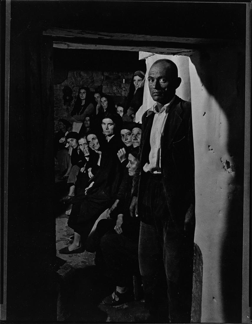 W. EUGENE SMITH (1918-1978) Spanish Wake (doorway).: W. EUGENE SMITH (1918-1978) Spanish Wake (doorway). Silver print, the image measuring 13½x10¾ inches (34.3x27.3 cm.), the sheet 14x11 inches (35.6x27.9 cm.), with the Estate of W. Eugene Smi