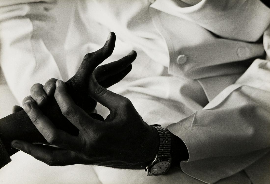 W. EUGENE SMITH (1918-1978) Doctor examining a child's: W. EUGENE SMITH (1918-1978) Doctor examining a child's hand, the Hospital for Special Surgery, New York. Silver print, the image measuring 8½x12 inches (21.6x31.4 cm.), the mount 13x18 inches (34
