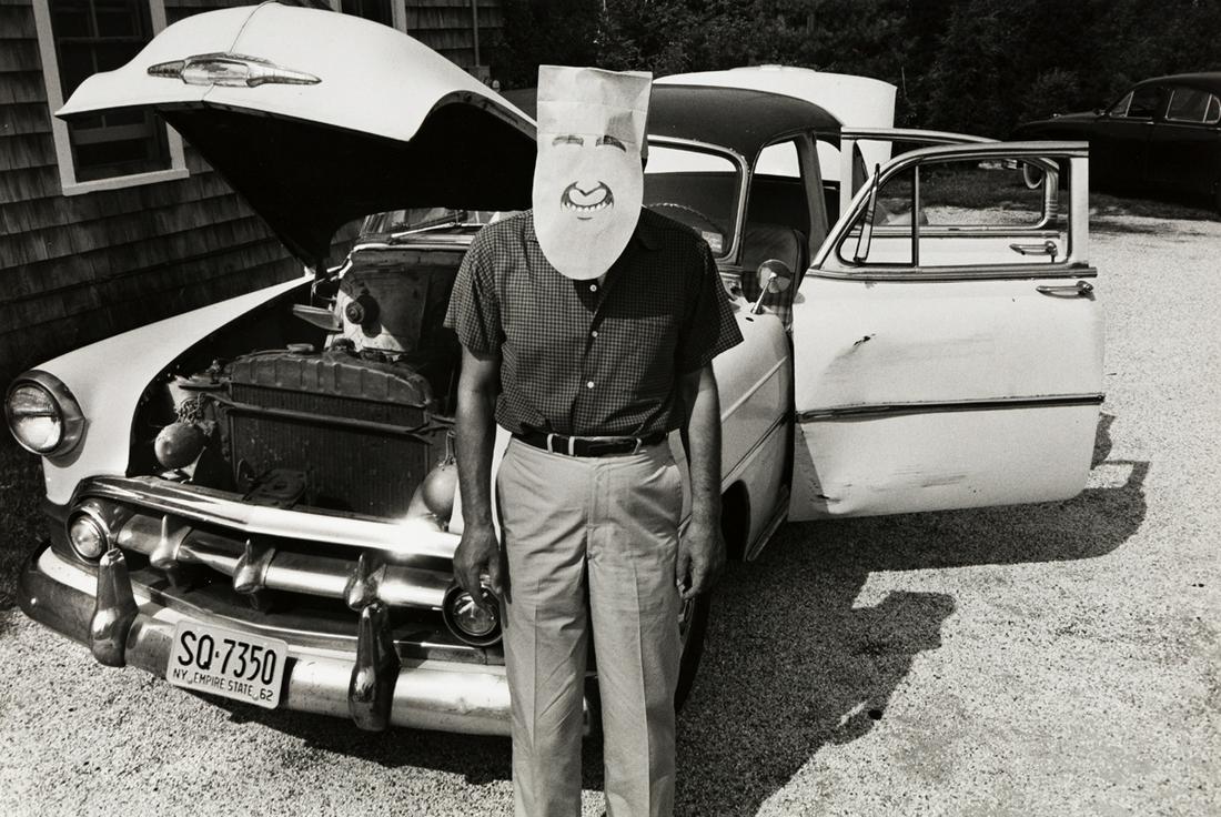 INGE MORATH (1923-2002) Man standing next to his car,: INGE MORATH (1923-2002) Man standing next to his car, from the Saul Steinberg Mask Series. Silver print, the image measuring 8x13 inches (21.9x33 cm.), the sheet 11x14 inches (27.9x35.6 cm.), with Mor