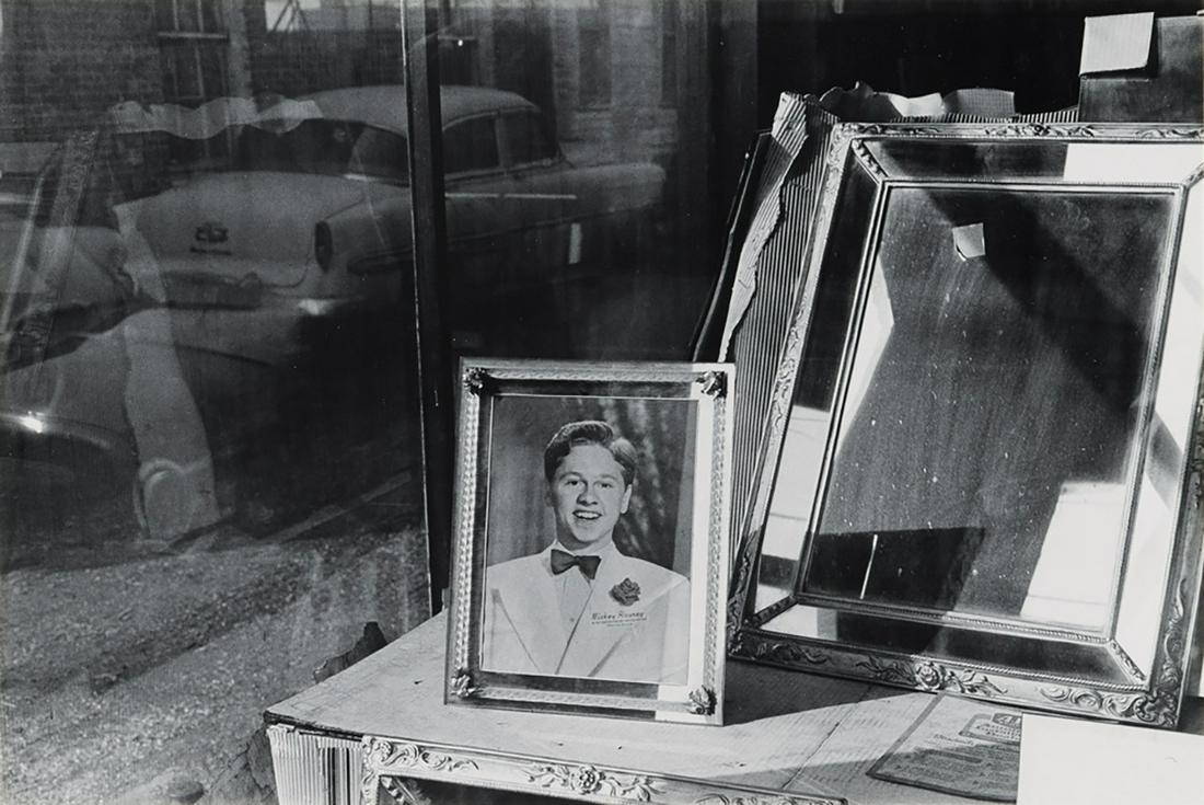 LEE FRIEDLANDER (1934- ) Mickey Rooney in window.: LEE FRIEDLANDER (1934- ) Mickey Rooney in window. Silver print, the image measuring 6¼x9 inches (15.9x23.8 cm.), the mount 14x10 inches (35.6x27.6 cm.), with Friedlander's signature and notation