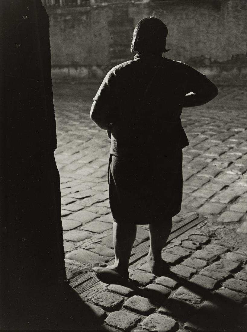 BRASSAÏ (1899-1984) Fille de joie, Quartier: BRASSAÏ (1899-1984) Fille de joie, Quartier Italie, Paris (de dos). Silver print, 14x10 inches (36.5x27 cm.), the sheet 15¾x11 inches (40x29.5 cm.), with Brassaï's signature, in ink, on