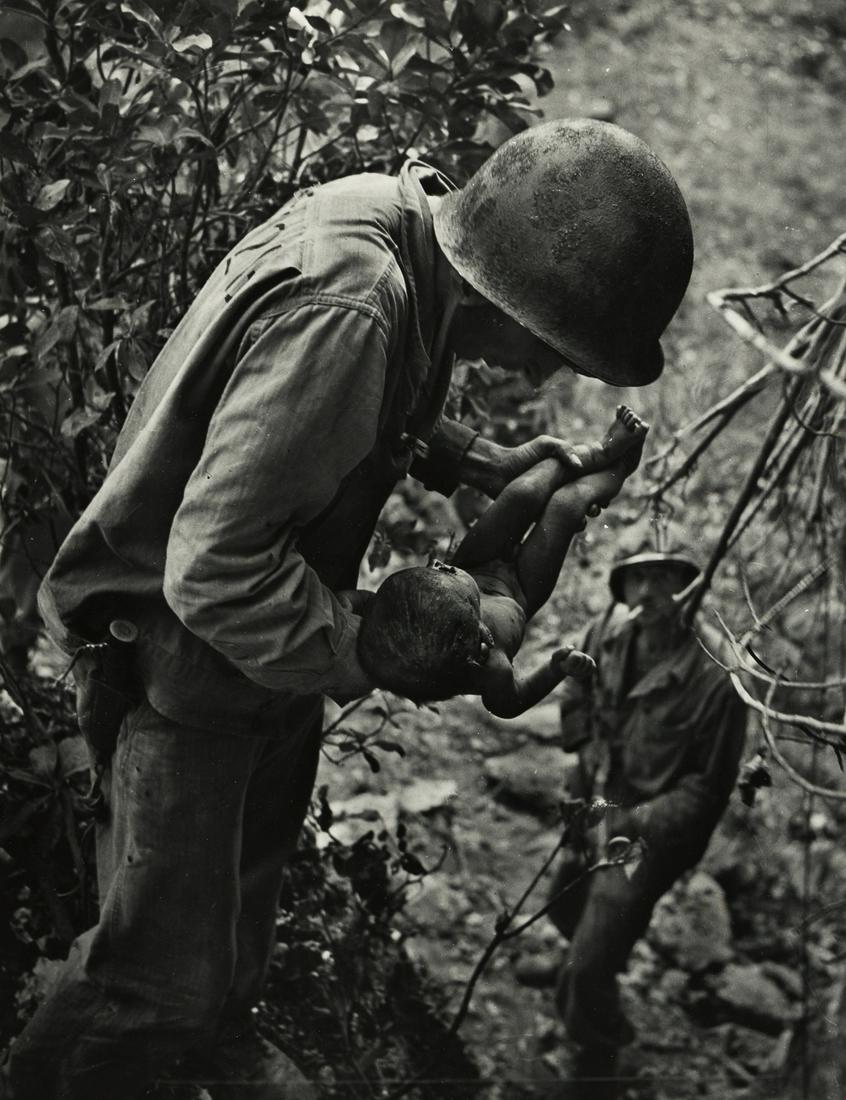 W. EUGENE SMITH (1918-1978) Saipan (soldier with an: W. EUGENE SMITH (1918-1978) Saipan (soldier with an infant). Silver print, the image measuring 18x13 inches (46x35.2 cm.), the sheet 20x15¾ inches (50.8x40 cm.), with Smith's copyright hand stamp