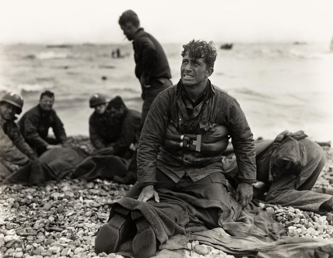 WALTER ROSENBLUM (1919-2006) D-Day Rescue, Normandy: WALTER ROSENBLUM (1919-2006) D-Day Rescue, Normandy Beach. Silver print, the image measuring 10½x13½ inches (26.7x34.3 cm.), the sheet slightly larger, flush mounted, with Rosenblum's signat