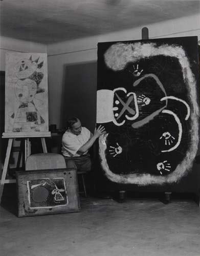 BRASSAÏ (1899-1984) "In his Barcelona studio J: BRASSAÏ (1899-1984) "In his Barcelona studio Joan Miró puts his handprint on canvas." Silver print, 14x11 inches (35.5x28 cm.), with Brassaï's signature on recto and his numeric notations, "catalog