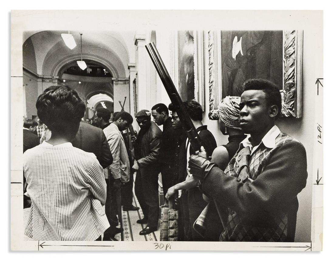 (BLACK PANTHERS.) Group of 3 press photographs of the Panthers marching in Sacramento.: (BLACK PANTHERS.) Group of 3 press photographs of the Panthers marching in Sacramento. 3 photographs, various sizes; captions and notations on verso, crop marks and notations on recto. Sacramento, CA,