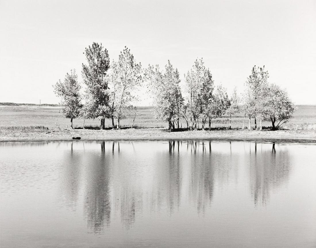 ROBERT ADAMS (1937- ) A farm pond about to be destroyed by earth moving machinery.: ROBERT ADAMS (1937- ) A farm pond about to be destroyed by earth moving machinery. Silver print, the image measuring 8x11¼ inches (22.5x28.6 cm.), the sheet 11x14 inches (27.9x35.6 cm.), with Ada