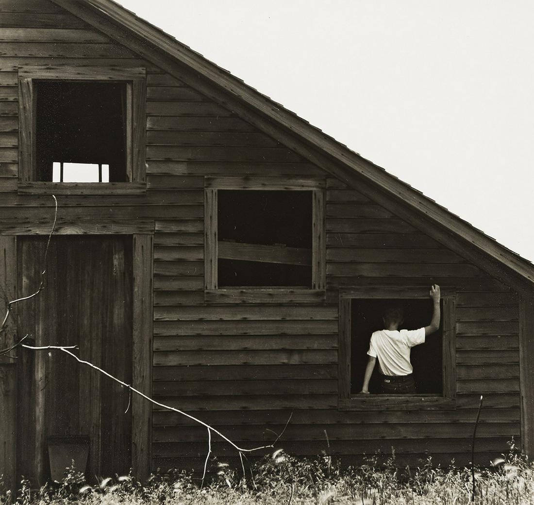 RALPH EUGENE MEATYARD (1925-1972) Untitled (Boy in window of barn).: RALPH EUGENE MEATYARD (1925-1972) Untitled (Boy in window of barn). Silver print, the image measuring 6x6 inches (15.9x17.1 cm.), the mount 14x11 inches (35.6x27.9 cm.), with Meatyard’s signatur