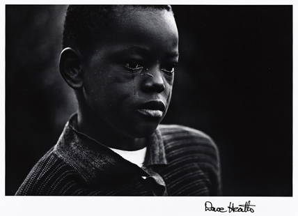 DAVE HEATH (1931-2016) New York City (young boy).: DAVE HEATH (1931-2016) New York City (young boy). Silver print, the image measuring 6x9½ inches (16.2x24.1 cm.), the sheet 8x10 inches (20.3x25.4 cm.), with Heath's signature in ink on recto, and