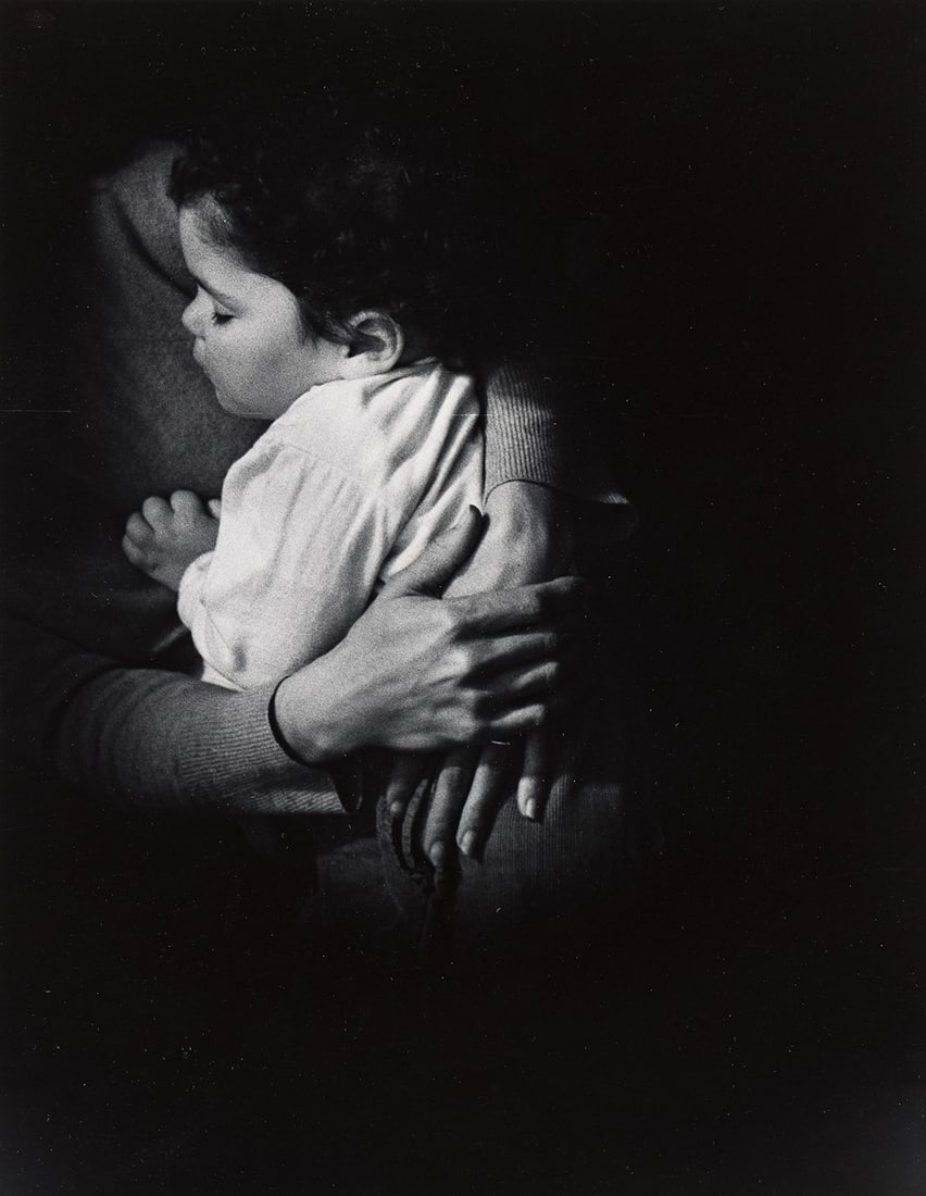 W. EUGENE SMITH (1918-1978) Baby held in mother’s arms.: W. EUGENE SMITH (1918-1978) Baby held in mother’s arms. Silver print, the image measuring 13x10 inches (34x26.4 cm.), the sheet slightly larger, with Smith's Estate stamp and printing notations