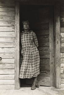 PETER SEKAER (1901-1950) Macon, Georgia (woman in doorway).: Macon, Georgia (woman in doorway). Silver print, the image measuring 197x130 mm; 7¾x5⅛ inches, with Christina Sekaer's signature, notation "This is an original photograph by Peter Sekaer,"