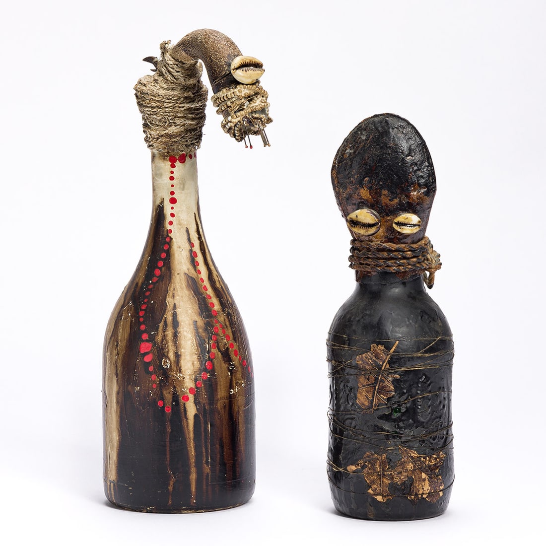 WANGECHI MUTU (1973 - ) Untitled (Bottle People Series).: WANGECHI MUTU (1973 - ) Untitled (Bottle People Series). A pair of mixed media and glass sculptures, 1997. Approx. 11½x4 inches and 9½x3 inches. Provenance: acquired directly from the artist