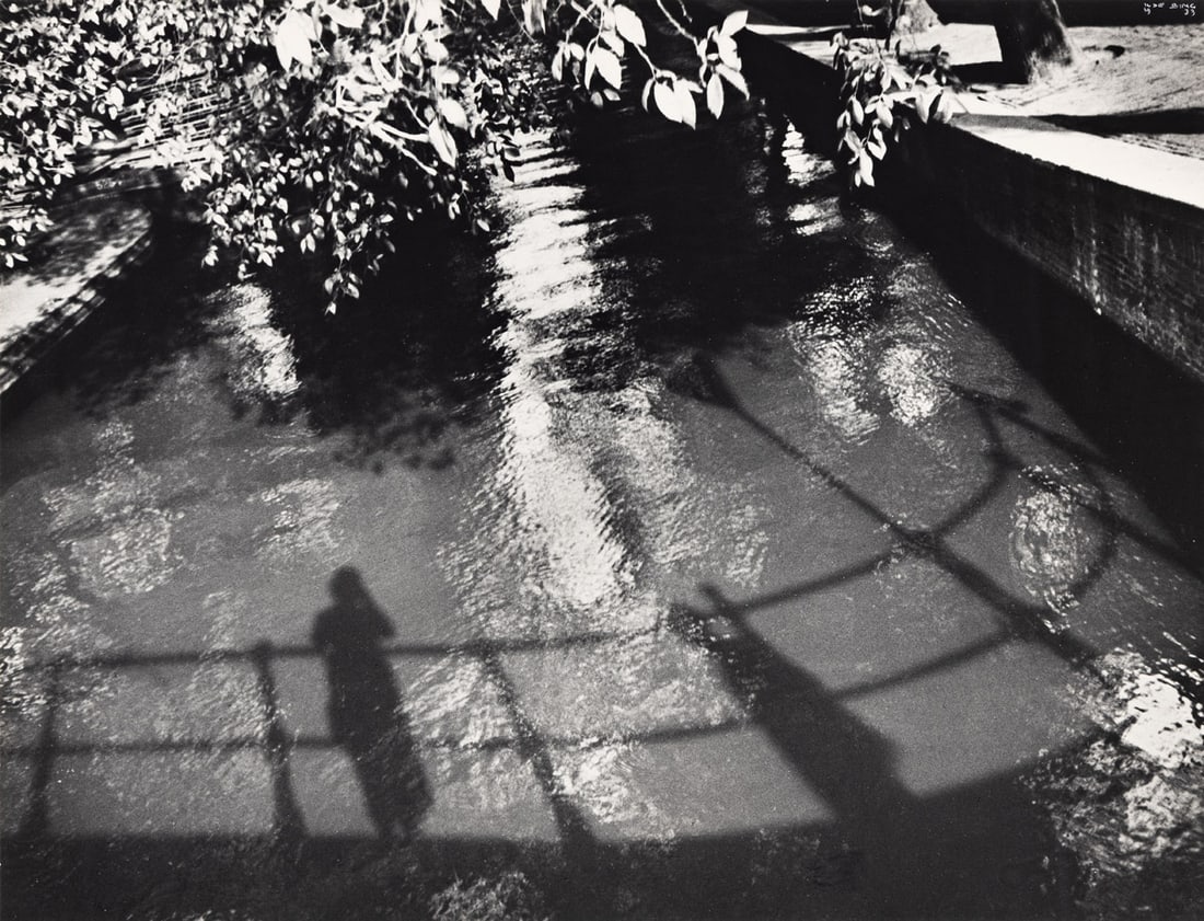 ILSE BING (1899-1998) Self-portrait (Canal Saint Martin, Paris).: ILSE BING (1899-1998) Self-portrait (Canal Saint Martin, Paris). Silver print, the image measuring 10⅛x13¼ inches (25.7x33.7 cm.), the mount slightly larger, with Bing's signature and date