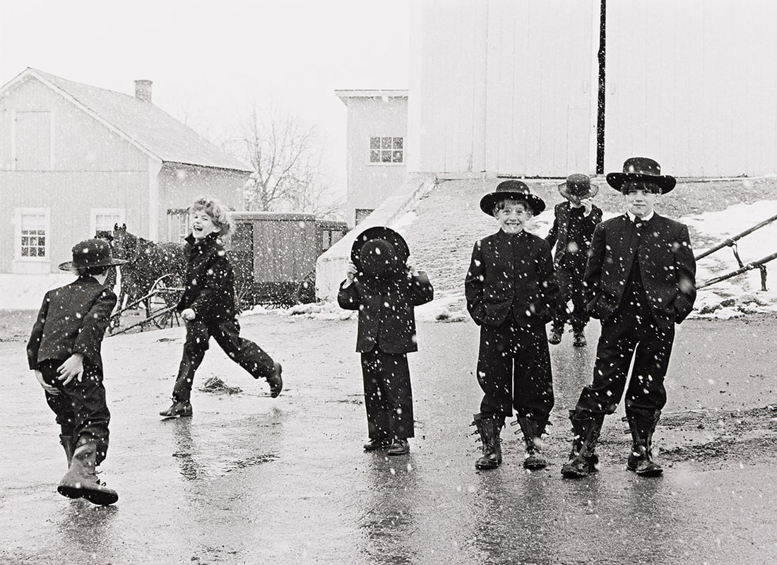 GEORGE A. TICE (1938- ) Amish Children Playing in Snow, Lancaster, Pennsylvania.: GEORGE A. TICE (1938- ) Amish Children Playing in Snow, Lancaster, Pennsylvania. Silver print, the image measuring 9¾x13½ inches (24.8x34.3 cm.), the mount 14x17 inches (35.6x43.2 cm.), with